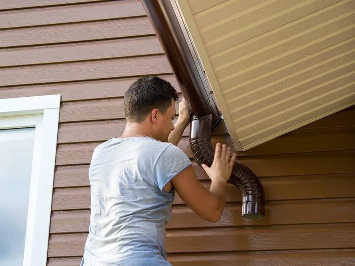 Seamless gutter and downspout installed along a roofline by Kingdom Roofing & Exteriors, Lebanon